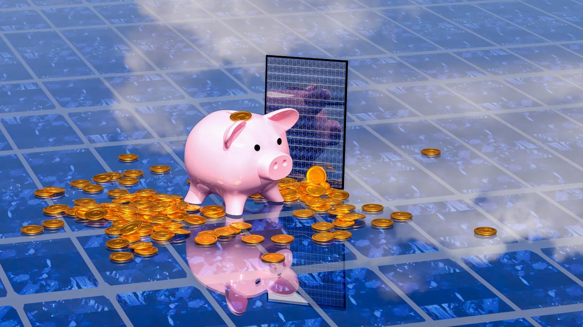 A piggy bank placed on a solar panel for the concept of saving energy